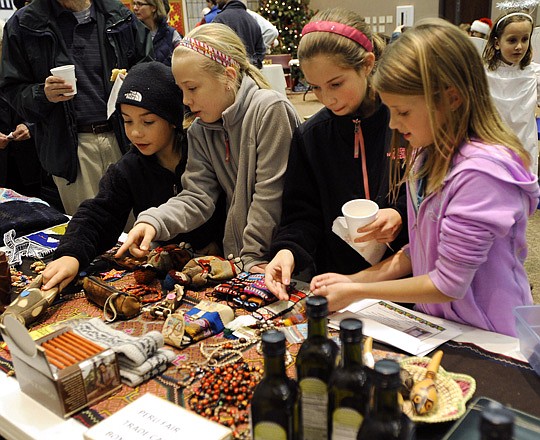 Children look over a collection of Central and South American Fair Trade items for sale during Living Windows at First Presbyterian Church.