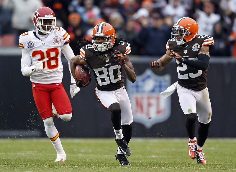 Cleveland Browns wide receiver Travis Benjamin (80) breaks away from Kansas City Chiefs cornerback Neiko Thorpe (38) on a 93-yard punt return for a touchdown in the second quarter of an NFL football game in Cleveland, Sunday, Dec. 9, 2012. Browns cornerback Joe Haden (23) blocks on the return. 