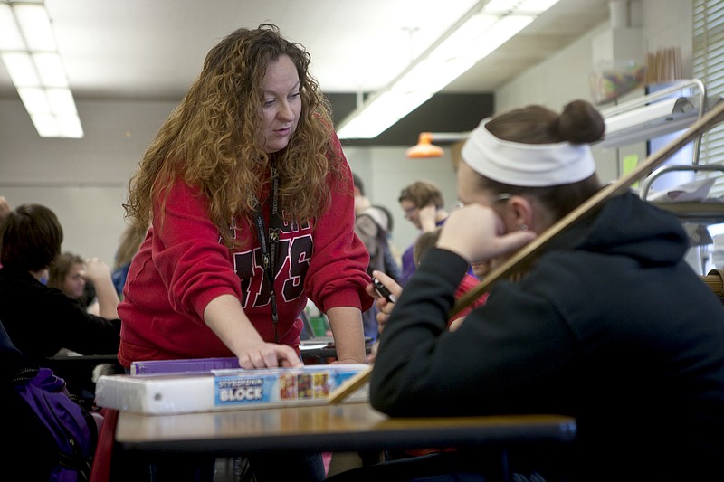 Rhiannon McKee assists a student during class at Jefferson City High School Tuesday afternoon. McKee and fellow teacher Abigail Nahlik are teaching a hybrid biology and literature class together this year.