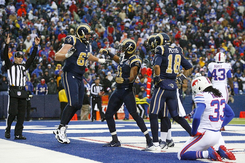 St. Louis Rams wide receiver Brandon Gibson (11) celebrates with teammates after catching a touchdown pass from quarterback Sam Bradford, not pictured, as Buffalo Bills cornerback Ron Brooks (33) reacts during the second half of an NFL football game, Sunday, Dec. 9, 2012, in Orchard Park, N.Y. The Rams won 15-12.