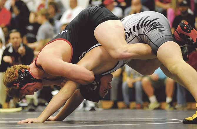 Zack Eggen of Jefferson City tries to maintain control of Robbie Sampson of Omaha Burke during their 195-pound match Saturday in the Missouri Duals at Helias High School.