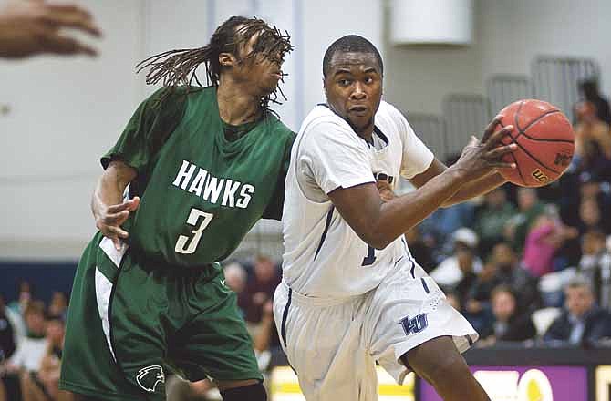 Lincoln guard Shakir Preston drives past Northeastern State guard Bryton Hobbs during Saturday afternoon's game at Jason Gymnasium in Jefferson City.