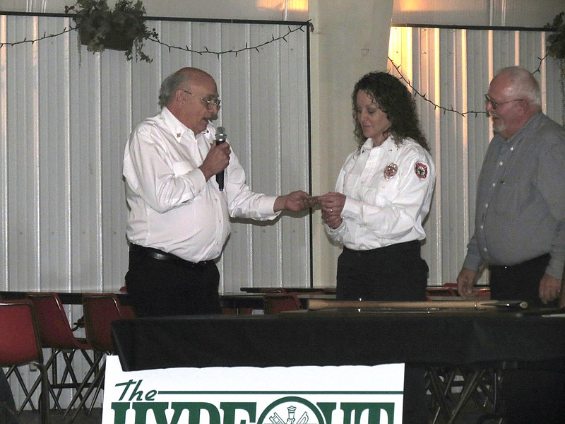 Longtime North Callaway Fire Protection District Chief Harley Hyde presents incoming Chief Lana Karhoff with her new badge. When Karhoff takes over leadership of the department in January, she will become the first female fire chief in Callaway County.                               