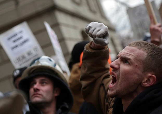 A crowd protests outside the state Capitol against two controversial right-to-work bills that the Michigan House of Representatives passed in Lansing, Mich., on Tuesday.