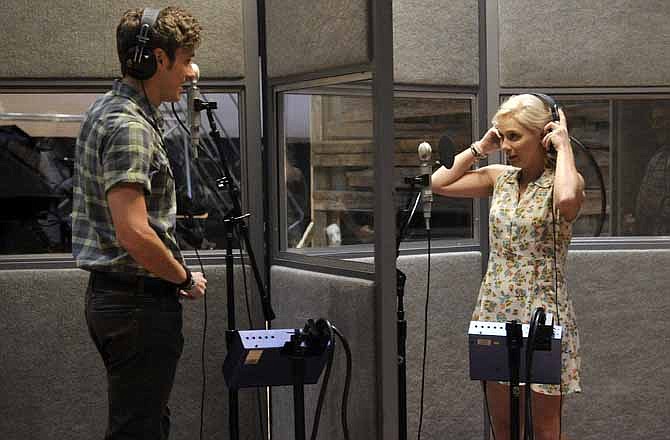 This Aug. 20, 2012 file photo shows Sam Palladio, who portrays Gunnar Scott, left, and Clare Bowen, who portrays Scarlett O' Connor, rehearse a scene on the set of ABC's "Nashville" in Nashville, Tenn. The music of "Nashville" has been as much a star on the hourlong ABC drama as Connie Britton, Hayden Panettiere, Charles Esten, Jonathan Jackson, Bowen and Palladio. Each actor sings their own part, and so far fans seem to be responding, buying more than 800,000 digital singles.