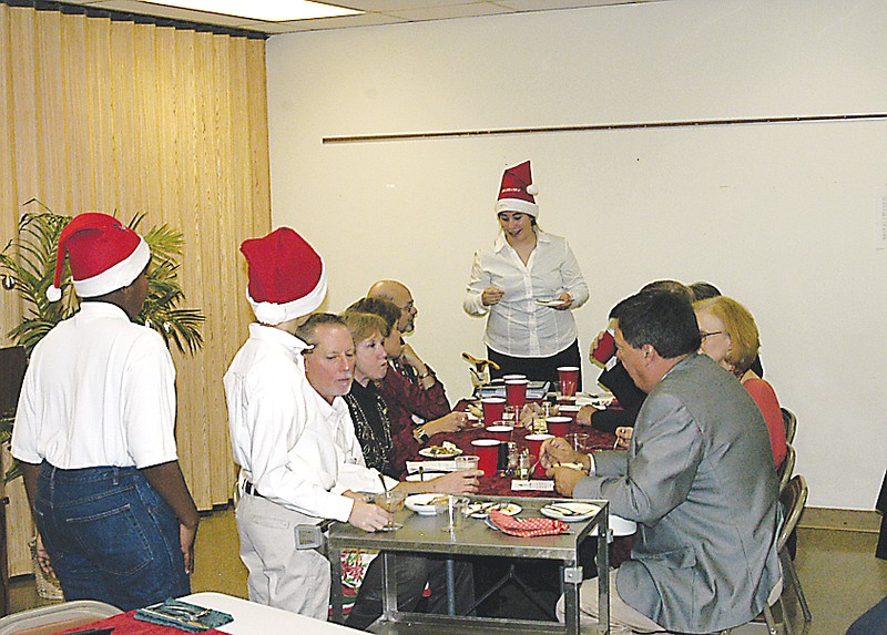 iners at the CPI annual dinner on Tuesday, Dec. 4, are served by Santa's helpers.