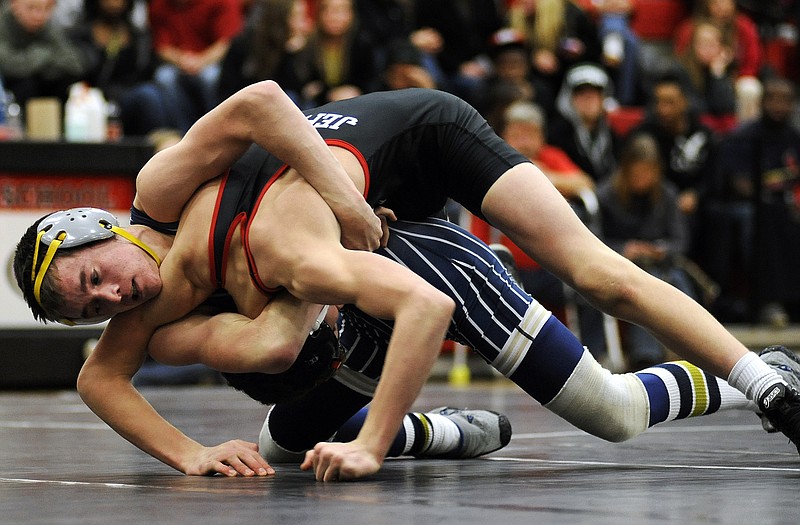 Dylan Lisenbardt of Helias torques Jefferson City's Damon Jones onto his shoulders in the 120-pound matchup during Wednesday's wrestling showdown between the Jays and the Crusaders at Fleming Fieldhouse.