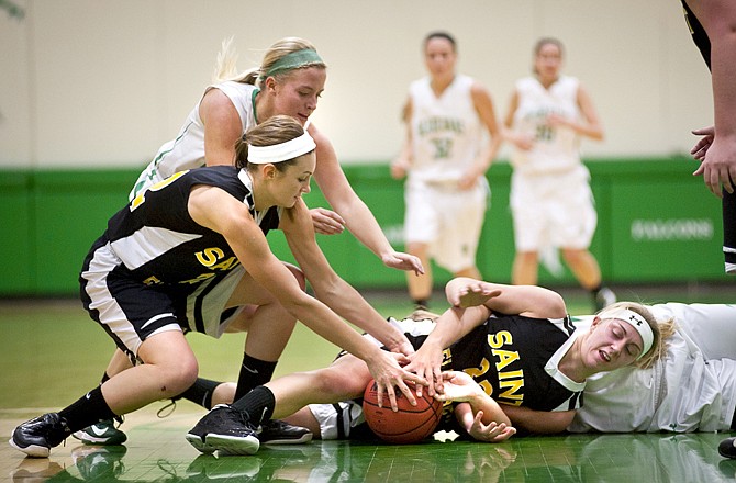 (From left) Blair Oaks' Sara Jones, St. Elizabeth's Megan Kemna and Savannah Stiles and Amy Dorge (hidden) of the Lady Falcons fight for a loose ball during Thursday night's game in Wardsville.