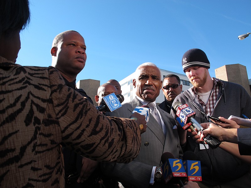 Memphis Police Department Director Toney Armstrong, left, and Memphis Mayor A C Wharton Jr., center, speak with reporters outside the Regional Medical Center after two police officers were involved in a shooting on Friday in Memphis, Tenn. One officer was killed and another officer was wounded. The wounded officer was being treated at the medical center.
