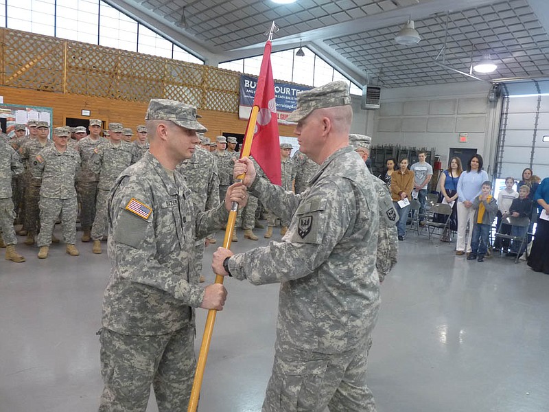 Missouri National Guard Capt. James Frazier, left, accepts the Company B, 311th Brigade Support Battalion guidon from brigade commander Lt. Col. Jeffrey Sloan. The new commander said he looked forward to maintaining a "hometown guard" atmosphere to the battalion.