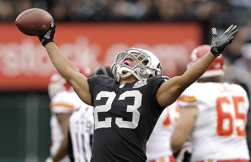 Oakland Raiders defensive back Joselio Hanson (23) celebrates after intercepting Kansas City Chiefs quarterback Brady Quinn during the second quarter of an NFL football game in Oakland, Calif., Sunday, Dec. 16, 2012.