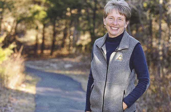 Robin Grumm, assistant manager of Runge Nature Center, poses for a photograph on the center's grounds in Jefferson City.