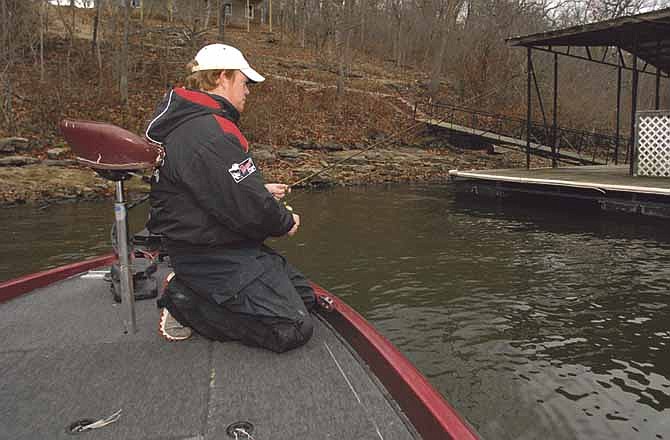 Travis Bunting fishes near a dock during a recent outing at the Lake of the Ozarks.