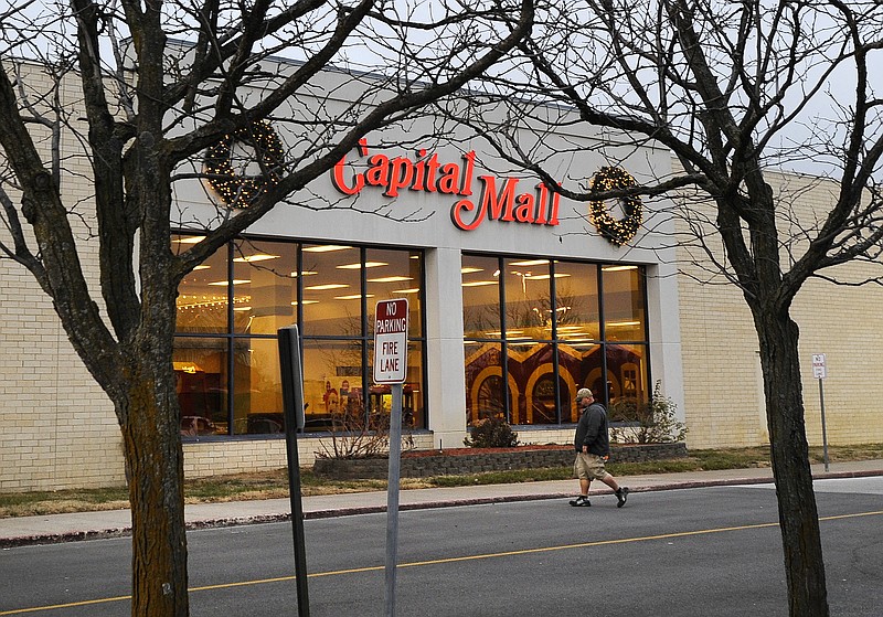 A shopper heads to the food court entrance on the south side of the Capital Mall on Dec. 17, 2012.