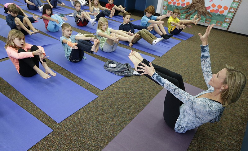 Yoga instructer Kristen McCloskey, right, leads a class of third graders at Olivenhain Pioneer Elementary School in Encinitas, Calif. Administrators of the Encinitas Union School District are treading softly as they pioneer what is believed to be the first district-wide yoga program of its kind, while trying to avoid a legal dispute over whether yoga is just exercise or an intrinsically spiritual practice. 