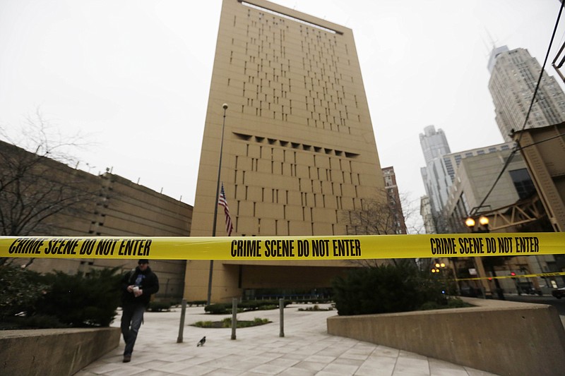 Police tape surrounds the Metropolitan Correctional Center Tuesday in Chicago. Two convicted bank robbers used a knotted rope or bed sheets to escape from the federal prison window high above downtown Chicago early Tuesday, a week after one of them made a courtroom vow of retribution, to a federal judge. The escape occurred sometime between 5 a.m. and 8:45 a.m. when the inmates were discovered missing, 