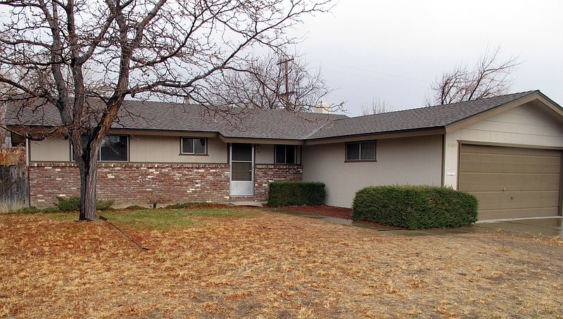 More than $7.4 million worth of gold coins, bars and bullion was left behind in the garage of Walter Samaszko Jr.'s home in Carson City, Nev. after his death in June. The home in a modest neighborhood a couple miles north of the state capital was sold at auction for $112,000 earlier this year and was sitting vacant in this photograph taken Monday.