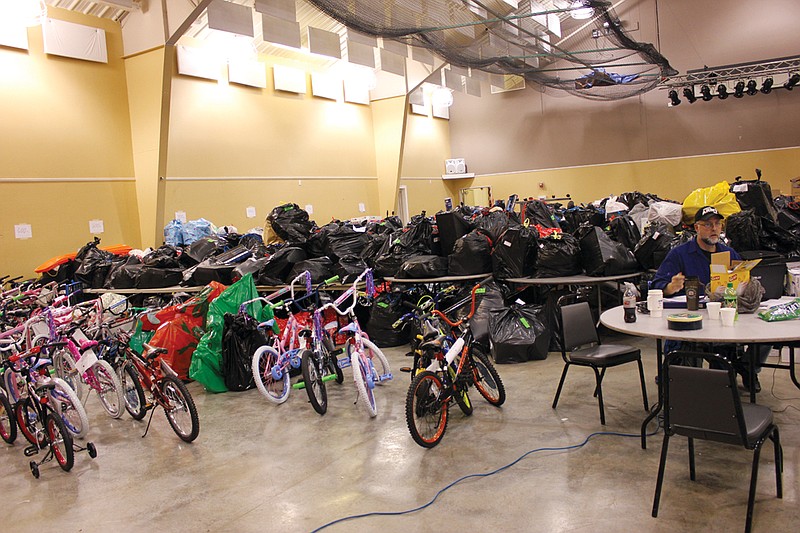 More than 700 bags, boxes and bikes were donated to SERVE, Inc. Monday during collection hours of their Adopt A Family drive. Each bag was stuffed with toys, clothes and other items for local low-income families, while the bikes were repaired and donated by Boy Scout Troop 50.