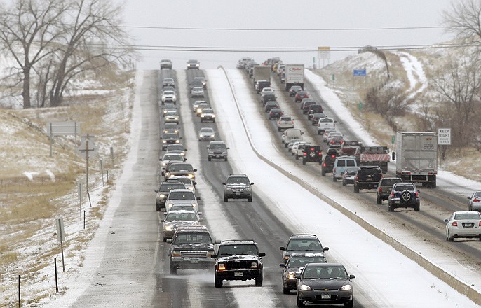 Traffic winds its way east and west along a snowy Boulder-Denver Turnpike, in Superior, Colo., Wednesday. A storm that has dumped more than a foot of snow in the Rocky Mountains is heading east and is forecast to bring the first major winter storm of the season to the central Plains and Midwest. 