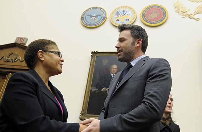 Ben Affleck, actor and founder of the Eastern Congo Initiative, shakes hands with Rep. Karen Bass, D-Calif., after arriving to testify before the House Armed Services Committee on the evolving security situation in the Democratic Republic of the Congo during a hearing on Capitol Hill in Washington, Wednesday, Dec. 19, 2012.
