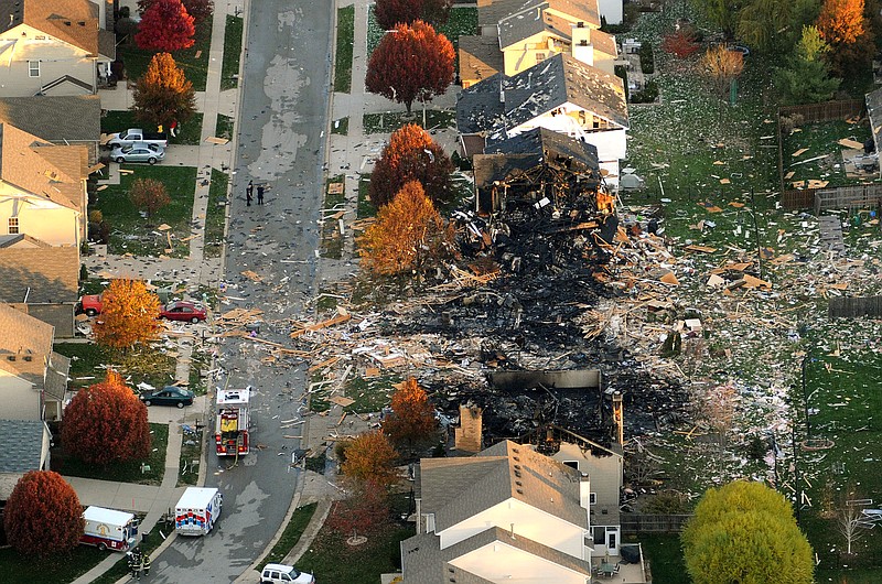 Debris is scattered about a neighborhood the day after two homes were leveled and numerous neighboring homes were damaged from a massive explosion that sparked a huge fire and killed two people in Indianapolis. Nearly three dozen homes were damaged or destroyed, and seven people were taken to a hospital with injuries.