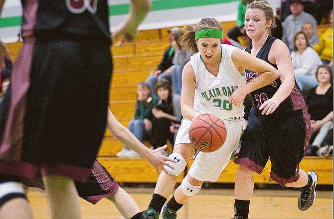 Blair Oaks' LeeAnn Polowy drives the ball to the basket during the Lady Falcons' game against Linn on Thursday night in Wardsville. 