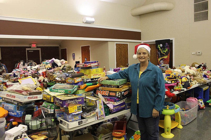 Connie Cashion poses with just a few of the items she gave away to Callaway's families in need during her annual free Christmas event at the John C. Harris Community Center in Fulton. Cashion, better known as "Miss Connie," collects clothes, games, hygeine products, furniture and other items year round to give away to those in need, and began holding a larger giveaway at the end of the year to commemorate the holiday season.