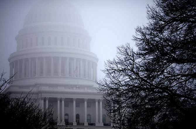 In this Dec. 10, 2012 file photo, fog obscures the Capitol dome on Capitol Hill in Washington. Big tax increases will hit millions of families and businesses a lot sooner than many realize if Congress and the White House don't agree on a plan to avoid the year-end fiscal cliff of automatic tax increases and government spending cuts. In fact, they already have. More than 70 tax breaks enjoyed by individuals and businesses already expired at the beginning of this year. If Congress doesn't extend them, a typical middle class family could get a $4,000 tax hike when they file their 2012 returns next spring, according to a private analysis. At the same time, businesses could lose dozens of tax breaks they have enjoyed for years.