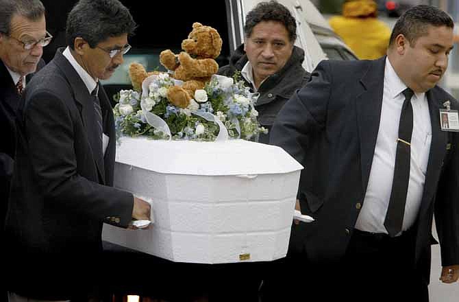 In this Jan. 23, 2009 file photo, pallbearers carry the casket of 4-year-old Roberto Lopez Jr., outside Our Lady of Angels Church in Los Angeles. The boy was shot in the chest a week earlier as he walked with his 5-year-old sister in a gang-plagued Echo Park neighborhood.