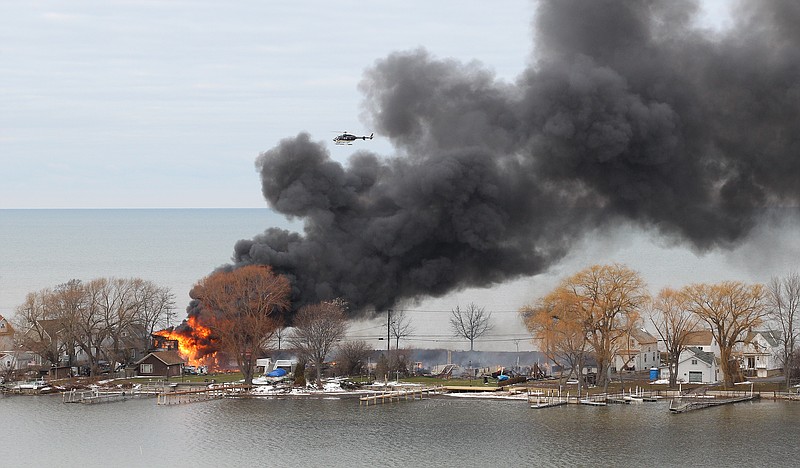 An ex-con set a car and a house ablaze Monday in his Webster, N.Y. lakeside neighborhood to lure firefighters, then opened fire on them, killing two, before engaging in a shootout with police and committing suicide while several homes burned. Authorities used an armored vehicle to evacuate the area.