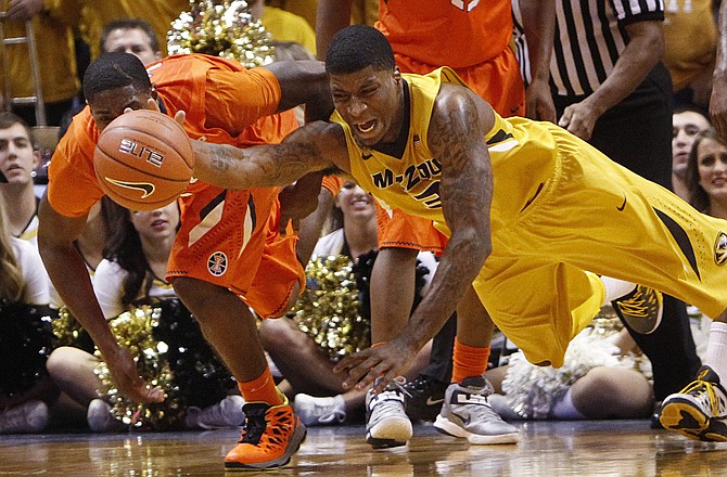 Missouri forward Tony Criswell chases after a loose ball with Illinois guard Brandon Paul during the second half of last Saturday's game in St. Louis. Criswell suffered a broken finger on his non-shooting hand in the game and will miss tonight's contest at UCLA.
