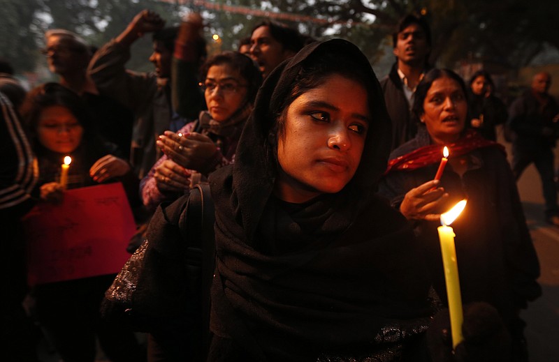 Indians participate in a candlelight vigil to seek a quick recovery of the young victim of the recent brutal gang-rape in a bus in New Delhi, India. A statement by Singapore's Mount Elizabeth hospital, where the 23-year-old victim was being treated, said she died Saturday.