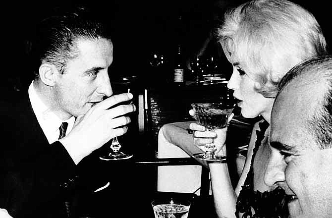 In this February 26, 1962 file photo, Marilyn Monroe and Jean Pierre Piquet, left, manager of Continental Hilton Hotel, are seen lifting their champagne glasses at a reception offered to the visiting star, in Mexico City. In late 2012, the FBI has released a new version of files it kept on Monroe that reveal the names of some of her acquaintances who had drawn concern from government officials and members of her entourage over their suspected ties to communism. 