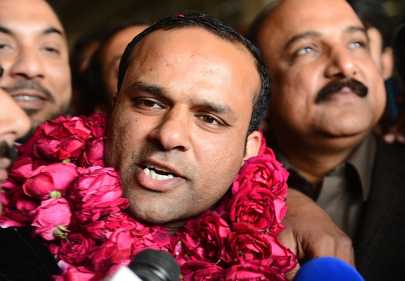 In this picture taken on Thursday, Dec. 27, 2012, Pakistani fans receive Muhammad Shahid Nazir, center, who sings "One Pound Fish," upon his arrival from London at Lahore airport in Pakistan. The 31-year-old Pakistani fishmonger catapulted to fame in recent weeks in the unlikeliest of circumstances: while hawking frozen snapper and mackerel for one British pound ($1.61) at Queens Market in London. "One Pound Fish changed my whole life," said Nazir, who returned to Pakistan to a hero's welcome and has been inundated with requests to perform and do advertisements. "I am so happy now."