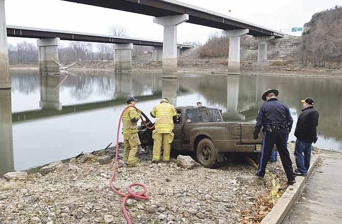 Members of the Osage Fire Protection District responded to a call from the Missouri Highway Patrol to hose out a truck recovered Friday from the shallow depths of the Osage River at Mari Osa Delta. The truck was reported stolen in Gasconade County in 2008 and was found earlier this week by a fisherman. 