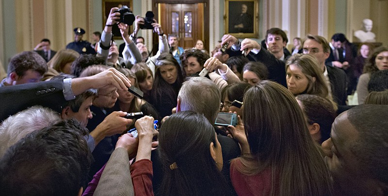 Reporters surround Assistant Majority Leader Sen. Richard Durbin, D-Ill., on Sunday outside the Senate chamber at the Capitol in Washington, during negotiations on the "fiscal cliff," the automatic tax increases and deep spending cuts that could kick in Jan. 1. Senate leaders remained at odds as the deadline draws perilously near.