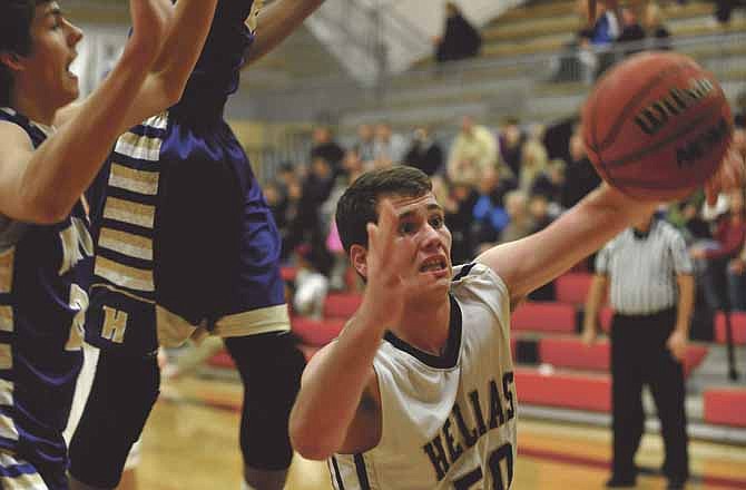 Hale Hentges of Helias reaches for a rebound in Saturday night's game at Fleming Fieldhouse.