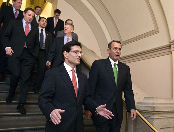 Speaker of the House John Boehner, R-Ohio, right, and House Majority Leader Eric Cantor, R-Va., left, walk to a second Republican conference meeting Tuesday to discuss the "fiscal cliff" bill passed by the Senate Monday night.