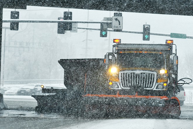 In this December 2012 photo, a MoDOT snowplow operator pulling a second plow makes his way toward U.S. 54 to clean both lanes of the highway in one pass.