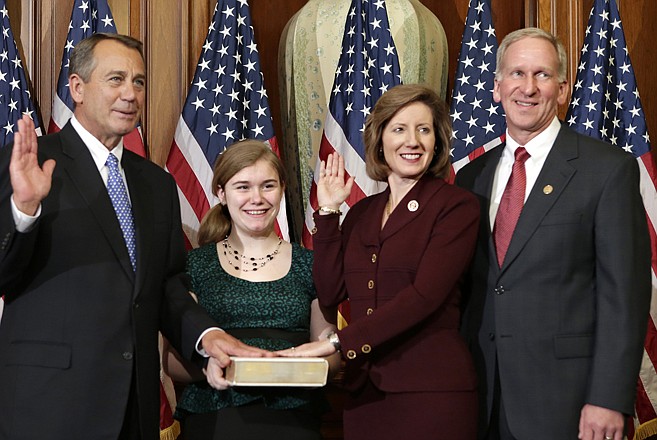 Rep. Vicky Hartzler, R-Mo., stands with her family for a ceremonial photo with Speaker of the House John Boehner, left, at the Capitol after the new 113th Congress convened on Thursday in Washington. 