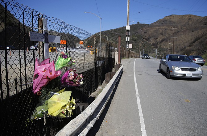 A roadside memorial sits by the 405 Freeway in Los Angeles where a paparazzo who killed by a car while darting across a street after taking pictures of Justin Bieber's Ferrari.