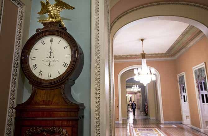 In this Tuesday, Jan. 1, 2013, file photo, the Ohio Clock strikes midnight as the Senate continues to work on the fiscal cliff, on Capitol Hill in Washington. The deal in Congress that stopped the country from going over the "fiscal cliff" removed one layer of uncertainty for small business owners who now have a sense of what their income taxes will be in 2013, but big issues still remain for them to worry about.