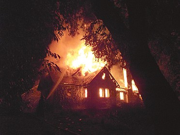 Firefighters work Friday to extinguish the flames of the home of a wealthy landowner in Temuco, Chile. Werner Luchsinger, 75, and wife Vivian McKay, whose family's vast landholdings have long been targeted by Mapuche Indians in southern Chile, were killed in the arson attack early Friday while trying to defend their home.
