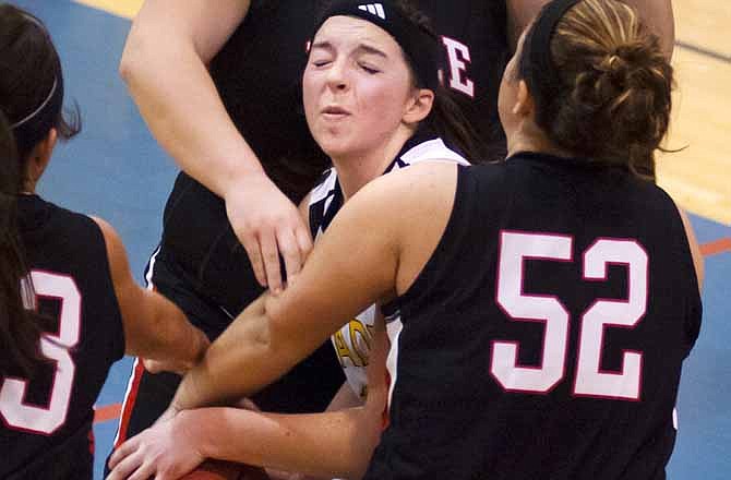 St. Elizabeth's Paige Otto battles a host of Belle Tigers for a rebound Saturday in the second half of the Calvary Lutheran Tournament title game at Trinity Lutheran in Jefferson City.