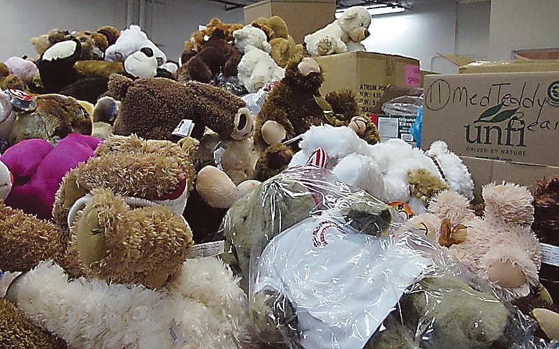 Piles of donated stuffed animals await sorting in a warehouse in Newtown, Conn.  