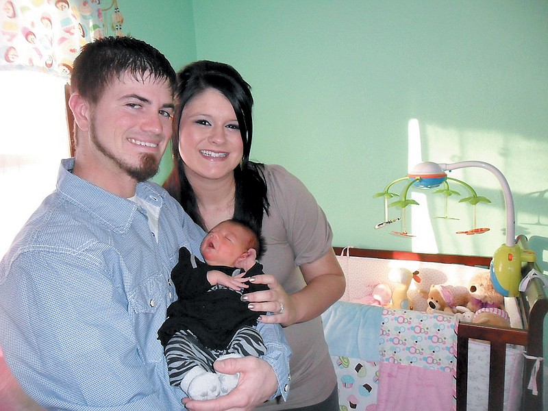 First-time parents Brandon and Kaylee Porter, California, proudly show off their daughter Rylee Michelle, who was born at 12:45 p.m. Tuesday, Jan. 1, at St. Mary's Health Center, Jefferson City, and shortly after was declared the winner of the 2013 Moniteau County First Baby Contest.