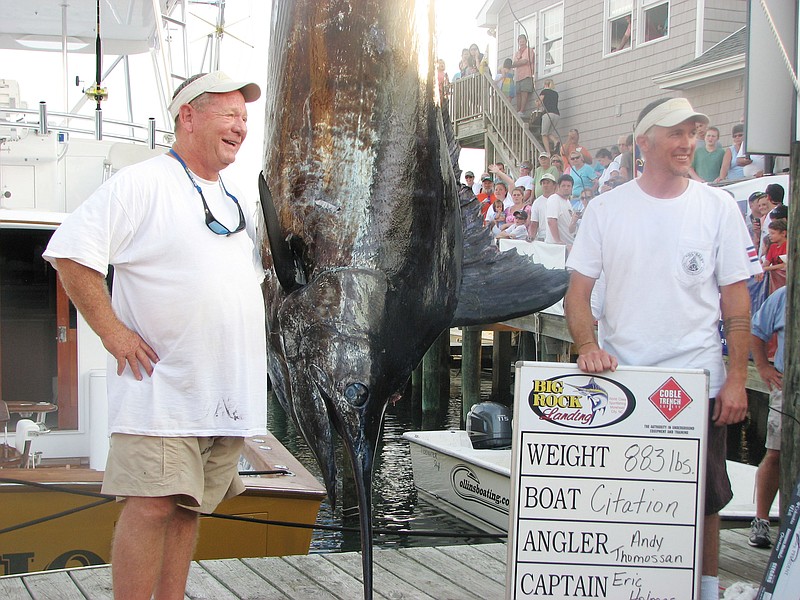 Citation angler Andy Thomossan, left, and Eric Holmes stand next to their 883-pound blue marlin in June 2010, which broke the record for the biggest blue marlin in the 52-year history of the Big Rock Blue Marlin Tournament in Morehead City, N.C. The boat's owners landed in a fight for the $910,000 in prize money that continued Tuesday with arguments to North Carolina's Supreme Court.