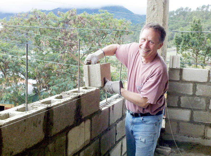 Bartz lays concrete blocks during construction of a second floor of a school he volunteered to help build in Constanza, Dominican Republic.
