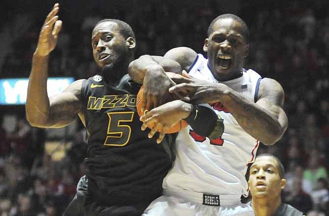 Mississippi's Murphy Holloway (31) and Missouri's Keion Bell (5) battle for the ball during an NCAA college basketball game at the C.M. "Tad" Smith Coliseum on Saturday, Jan. 12, 2013.