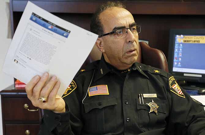 In this photo made on Wednesday, Jan. 9, 2013, Jefferson County Sheriff Fred Abdalla shows a printout of one of the web pages they are monitoring while in his office in Steubenville, Ohio. Abdalla said there was a post where someone said they were raped, only to recant the accusation in another post. The school district and city, which are in Jefferson County, have been under scrutiny since the alleged attack over the summer and the arrests of the two players. Some question why other students weren't charged, and bloggers and hacker-activists have alleged a cover-up meant to protect the popular football program.